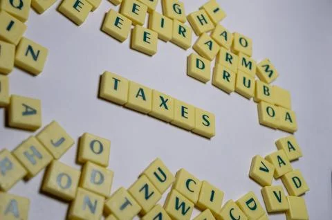 Representation of few letter blocks in which taxes are highlighted Stock Photos
