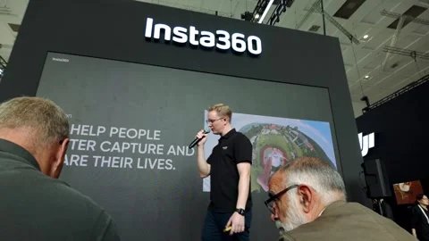 Representative of camera company Insta360 gives a presentation to crowd at a Stock Footage 317697920