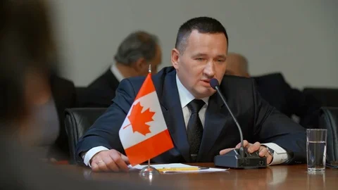 The representative of Canada ponders the question of development of territories Video stock 76390316