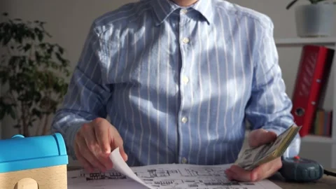 A representative of a developer, designer, realtor with money in hand explains Stock Footage 306780654
