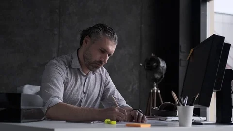 A representative middle-aged man works with documents in the office. portrait of Stock Footage 108615440