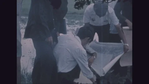 Representatives look at map to check on ownership of land - 1971 Stock Footage 97900542