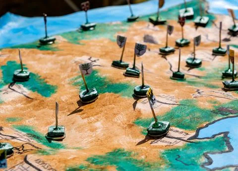 Reproduction of an ancient medieval map with flags to mark the war dispositio Stock Photos