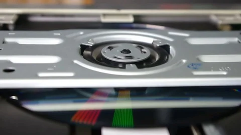 Reproduction and stop of DVD of a disk in the disk drive (close up) Stock Footage 81139018