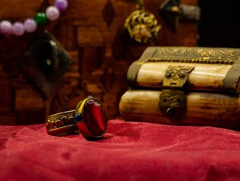 Reproduction golden ring with ruby gem decorated medieval with an ivory caske 스톡 사진