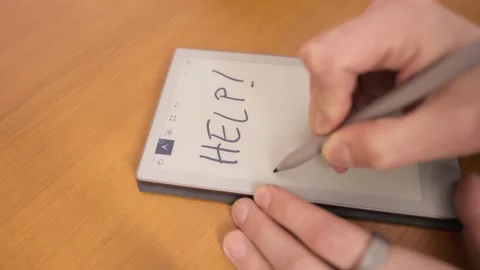 Request for help quickly written on an electronic notepad. Call and an attempt Stock Footage 330999516