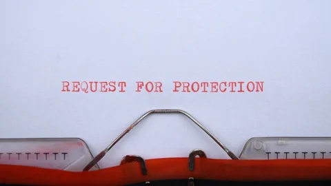 Request for protection - phrase printed on an old typewriter in red letters Video stock 128400781
