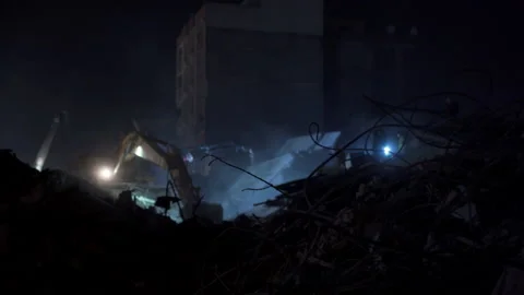 Rescue activity for people trapped under piles of iron and concrete. Stock Footage 233221476