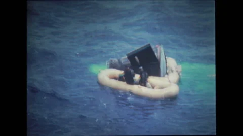 Rescue divers helping astronauts get out of the spacecraft Stock Footage