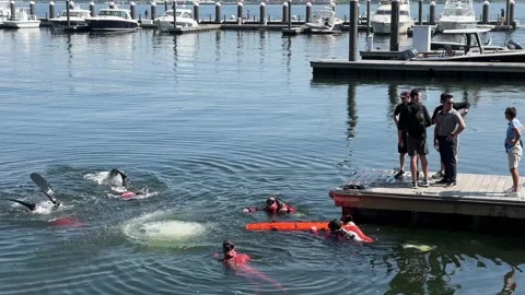 Rescue Exercise - swimmers rescue a water jumper  Stock Footage 242777067
