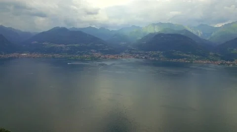 Rescue helicopter fly over Como Lake aerial 4k cloudy day. Famous tourist sites Stock Footage 67548128