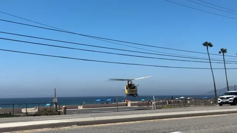 Rescue Helicopter Taking Off from Malibu Beach, Emergency Flight Editorial Stock Footage 334065382
