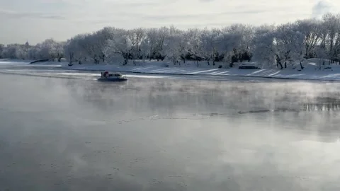 A rescue hovercraft navigates a frozen river Stock Footage 330978858
