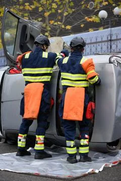 Rescue intervention team trying to save a victim from a car accident Stock Photos