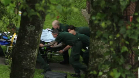 Rescue operation. Group of paramedics  pushing the patient on the trolley. 動画素材 40607111