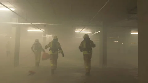 Rescue operation in an underground parking lot in smoke Stock Footage 266408904