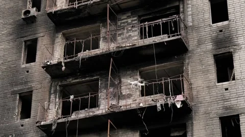 Rescue service drone flies in front of a burned-out high-rise building during Stock Footage 206108398