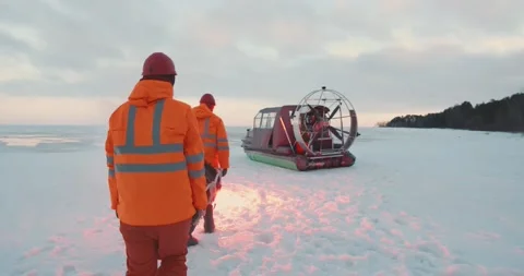 Rescue service team loading victim on stretcher in air-boat patrolling coast in Stock Footage 152154045