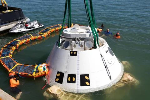 Rescue team members remove the stabilization collar from the Boeing CST-10... Stock Photos