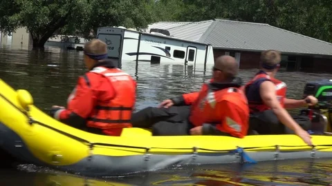 Rescue team passing flooded road on inflatable boats after hurricane Harvey Stock Footage