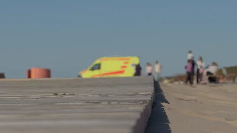 Rescue team scene. Beachside ambulance crew provides urgent medical assistance Stock Footage 333984202