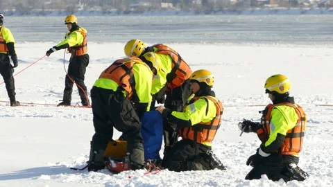 Rescue technicians loading bag with equipment while outdoor in winter Stock Footage 88694485