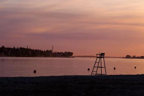 Rescue tower on the beach on sunset background Stock Photos
