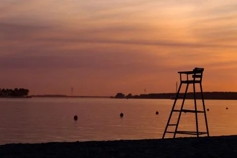 Rescue tower on the beach on sunset background Stock Photos