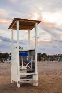 Rescue tower. Vacation concept. Empty sea beach. Sunset at a lifeguard tower in Stock Photos