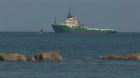 Rescue tug with sailboat Stock Footage 33606511