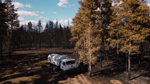 Rescue Vehicle On The Background Of The Burned Forest Drone Video Stock Footage 165190953