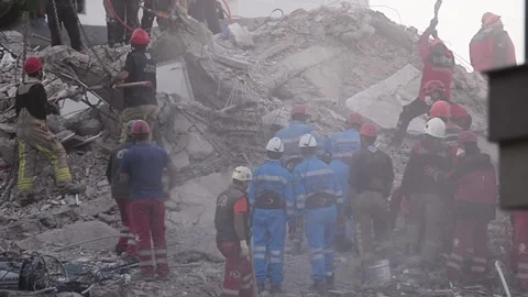 Rescue work is on for survivors in a collapsed building. Stock Footage 142474334