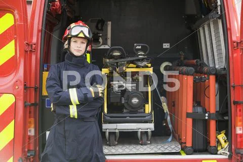 Rescue worker standing by open back door of rescue vehicle Stock Photos