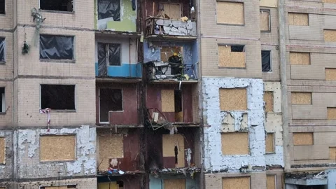 Rescue workers sort through burned and destroyed items in the apartment of .. Stock Footage 260501206