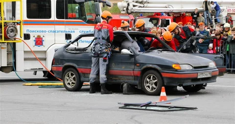Rescuers carry out a special operation to release people from the car in an Stock Footage 113742553
