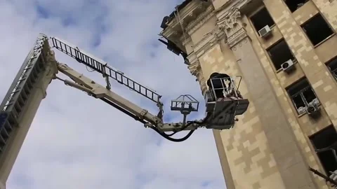 Rescuers clear rubble after being hit by Russian missiles Video stock 188748619