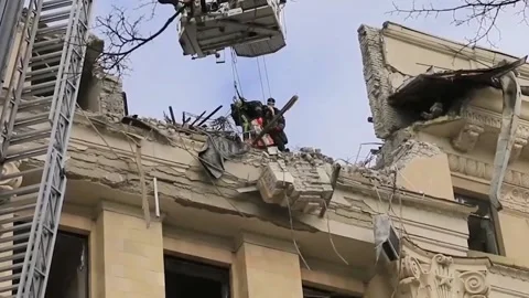 Rescuers clear rubble after being hit by Russian missiles 5 Video stock 188748639