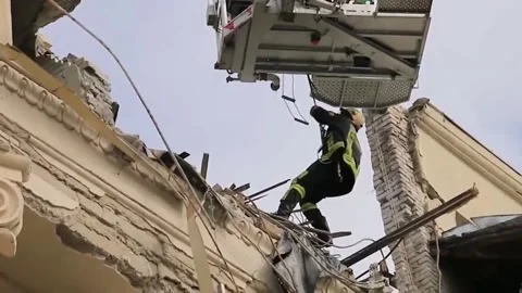 Rescuers clear rubble after being hit by Russian missiles 2 Stock Footage 188748959