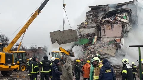 Rescuers clear the rubble of a missile attack on a residential building Stock Footage 319418904