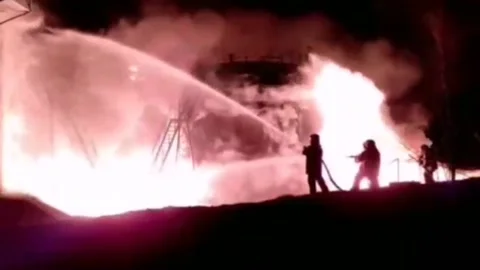 Rescuers put out a fire after being hit by Russian missiles3 Video stock 172773012
