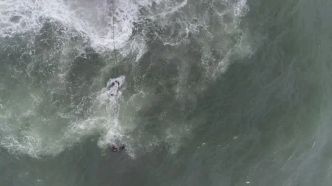Rescuers on the shore pulling the rope attached to the body recovered from Stock Footage 281103919