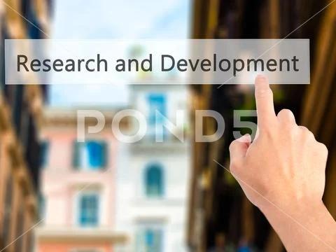 Research and Development - Hand pressing a button on blurred bac Stock Photos