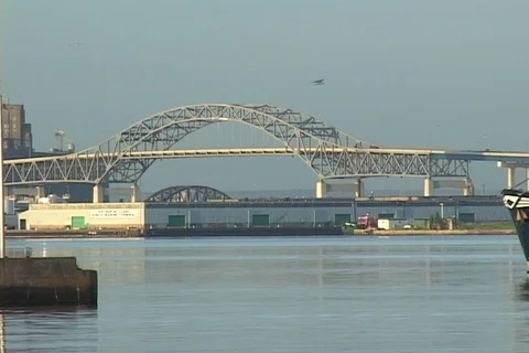 Research boat approaching dock, freeway bridge behind Stock Footage 124568531