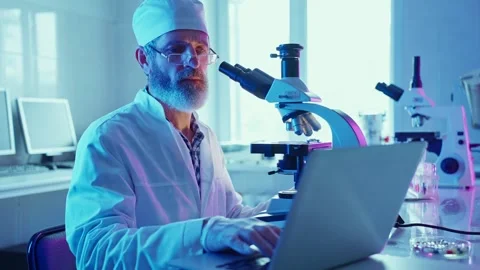 Research Chemist Analyzing Samples in Neon-Lit Laboratory in the Evening Stock Footage 287276077