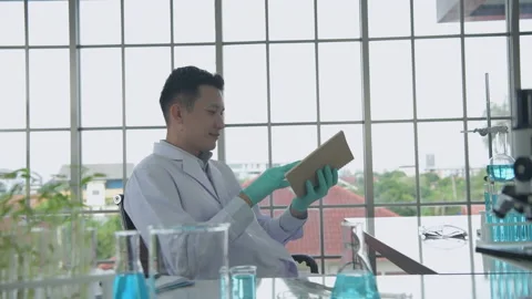 Research concept of 4k resolution. Asian scientists are searching for informa Stock Footage 205858827