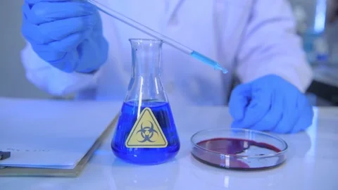 Research concept of 4k resolution. A scientist dripping liquid into a test tu Stock Footage 149525109