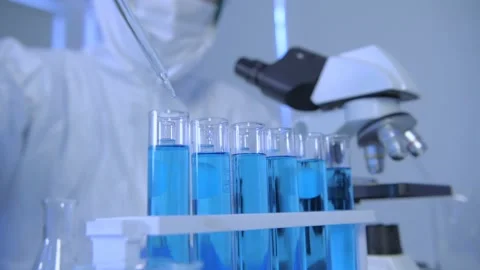 Research concept of 4k resolution. A scientist dripping liquid into a test tu Stock Footage 150176899