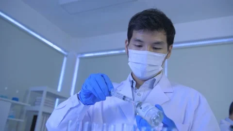 Research concept of 4k resolution. Scientists are dropping the vaccine into a Stock Footage 148866669