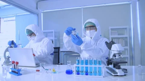 Research concept of 4k resolution. Scientists wear protective clothing to wor Stock Footage 154857370