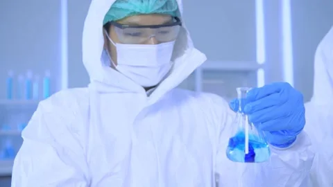 Research concept of 4k resolution. Scientists are examining the solution in a Stock Footage 156463043